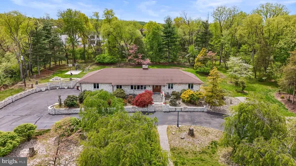an aerial view of a house with a yard basket ball court and outdoor seating