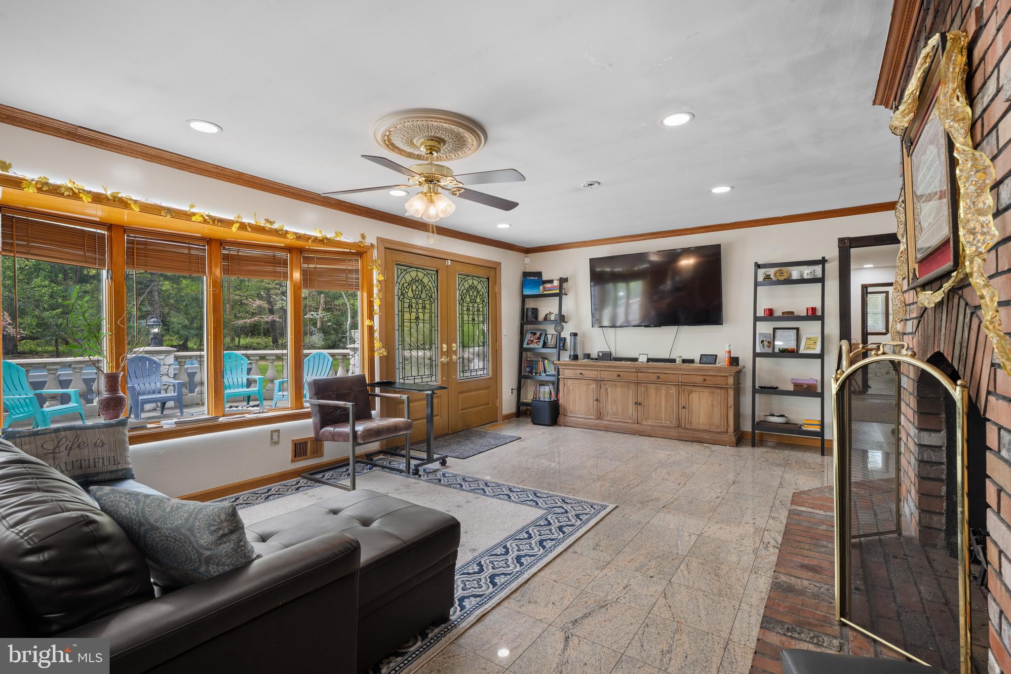 173 Butler Road Princeton, NJ 08540 - Photo 21 of 68 a living room with furniture a flat screen tv and a floor to ceiling window