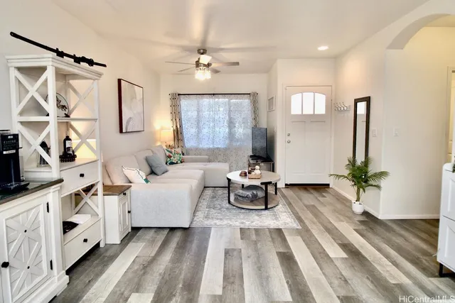 a living room with furniture and wooden floor