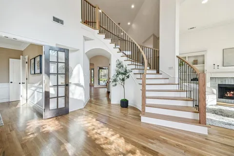 a view of entryway and hall with wooden floor