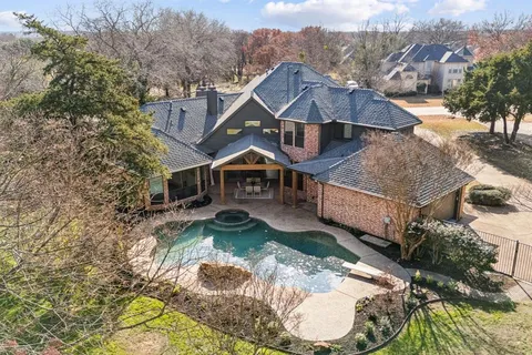 a aerial view of a house with a yard basket ball court and a outdoor view
