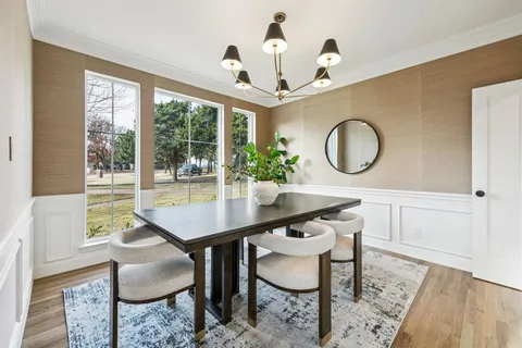 a view of a dining room with furniture and a chandelier