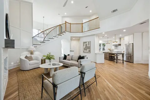a living room with furniture a table and a large window