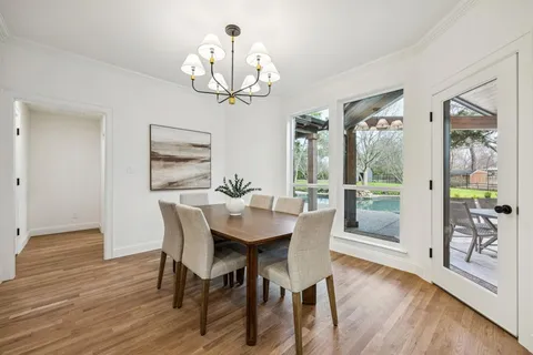a bathroom with a granite countertop sink a mirror and shower