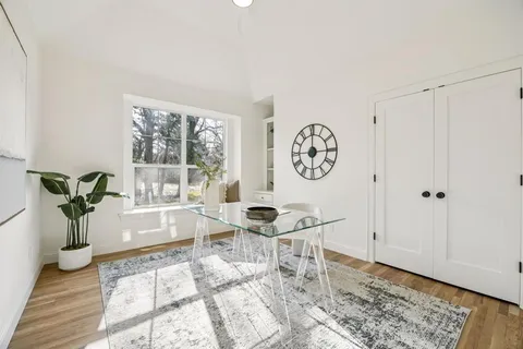 a living room with a couch and a floor to ceiling window