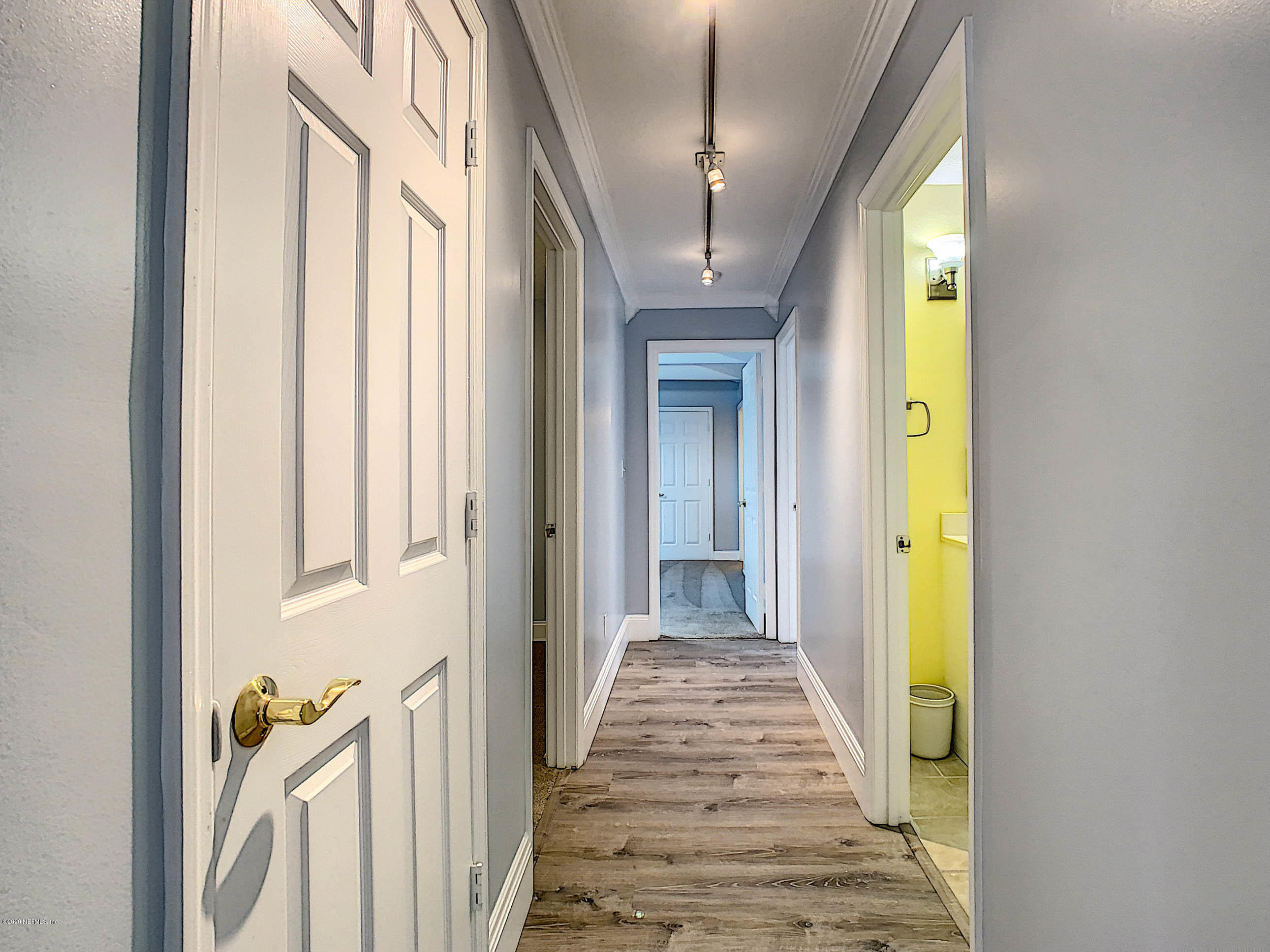 1609 First Street Neptune Beach, FL 32266 - Photo 11 of 30 a view of a hallway with wooden floor and staircase