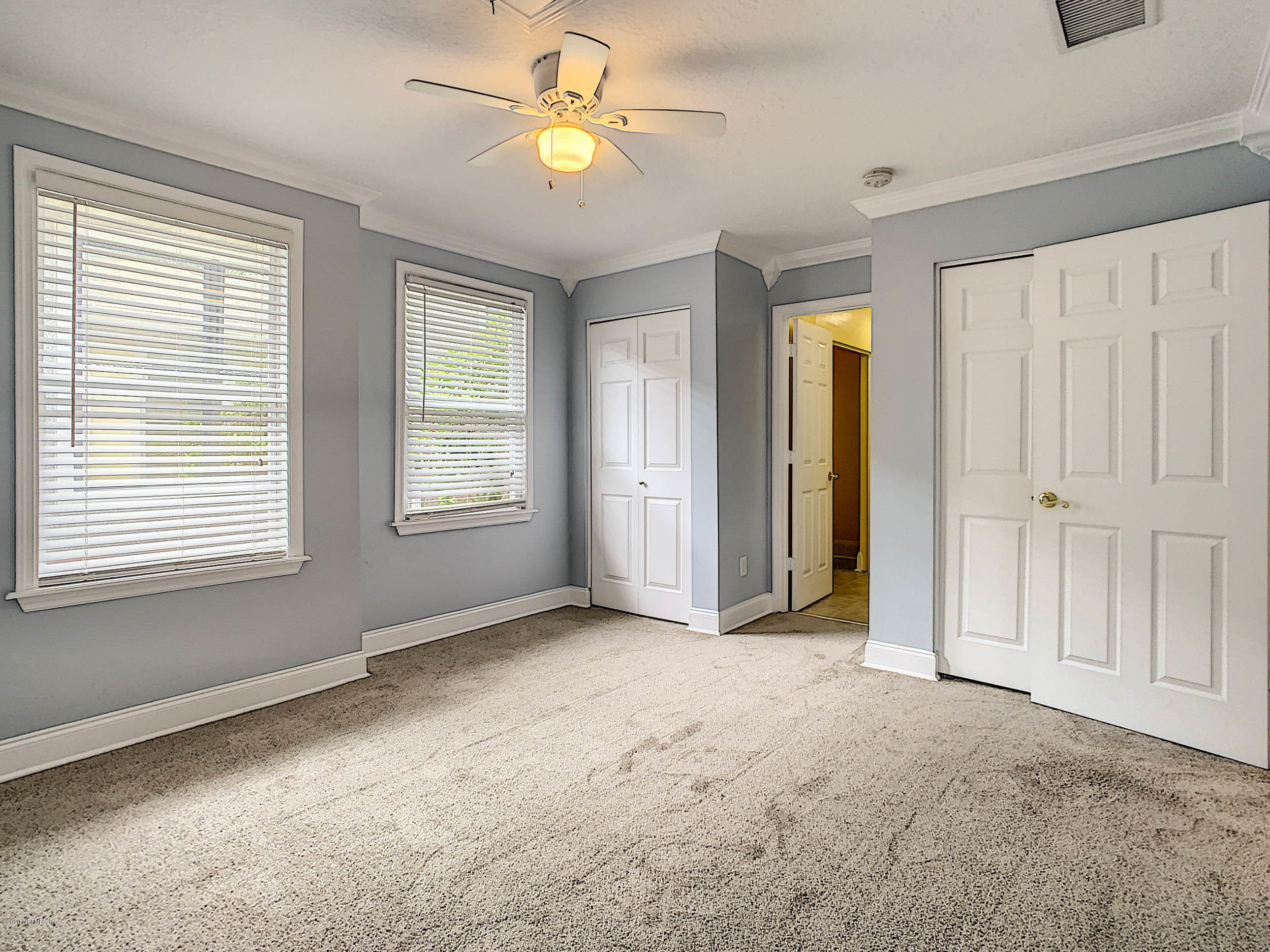 1609 First Street Neptune Beach, FL 32266 - Photo 14 of 30 a view of empty room with windows and ceiling fan