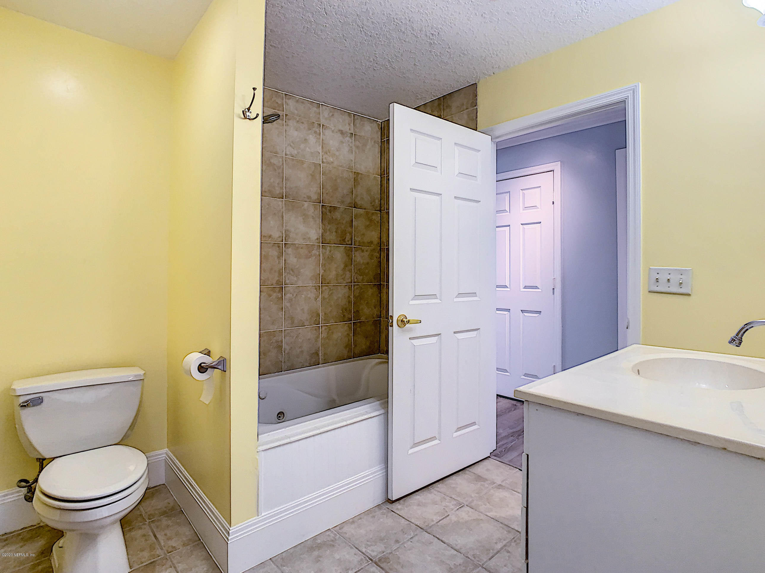 1609 First Street Neptune Beach, FL 32266 - Photo 16 of 30 a bathroom with a sink a toilet and shower
