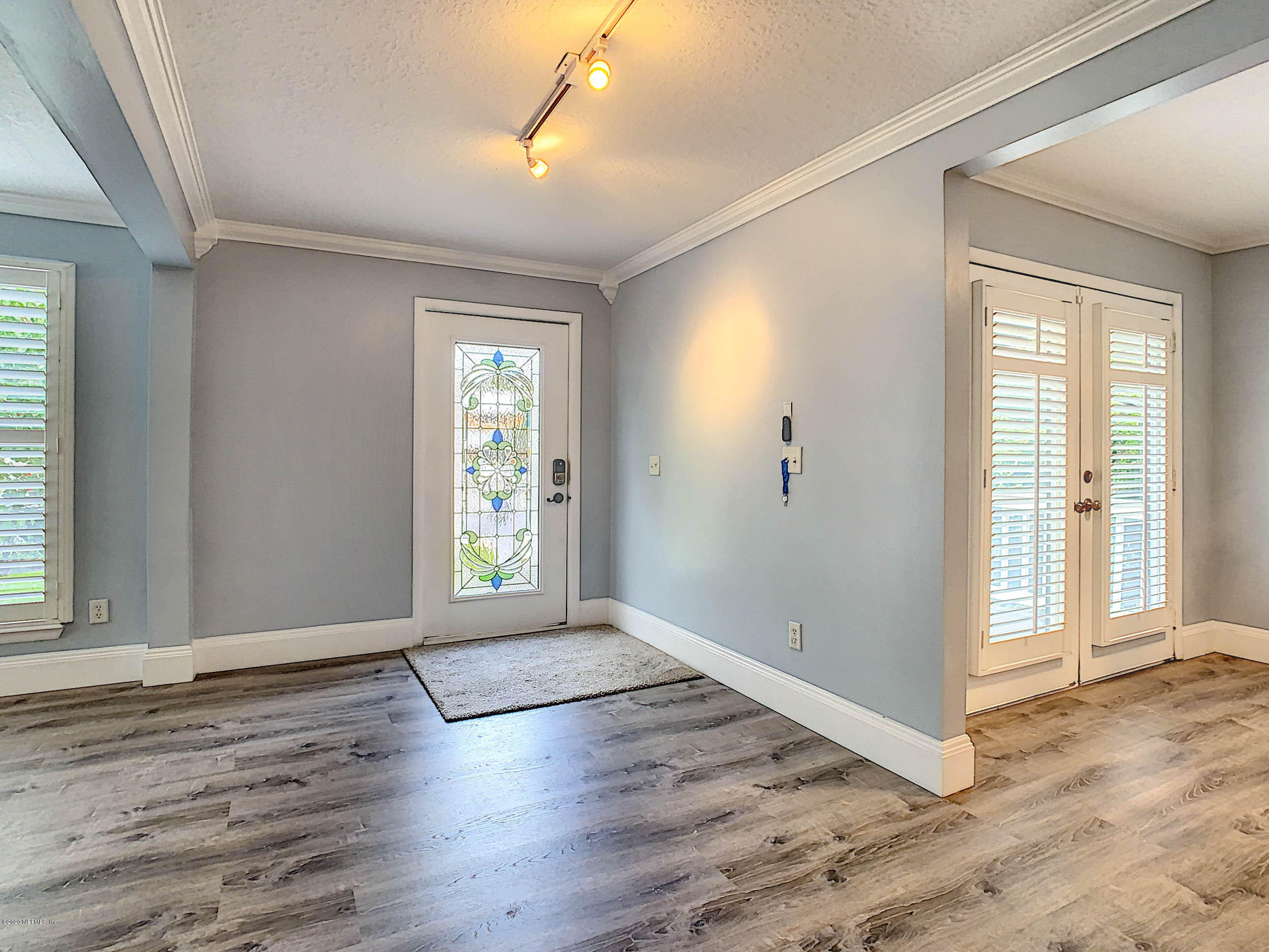 1609 First Street Neptune Beach, FL 32266 - Photo 2 of 30 an empty room with wooden floor and windows