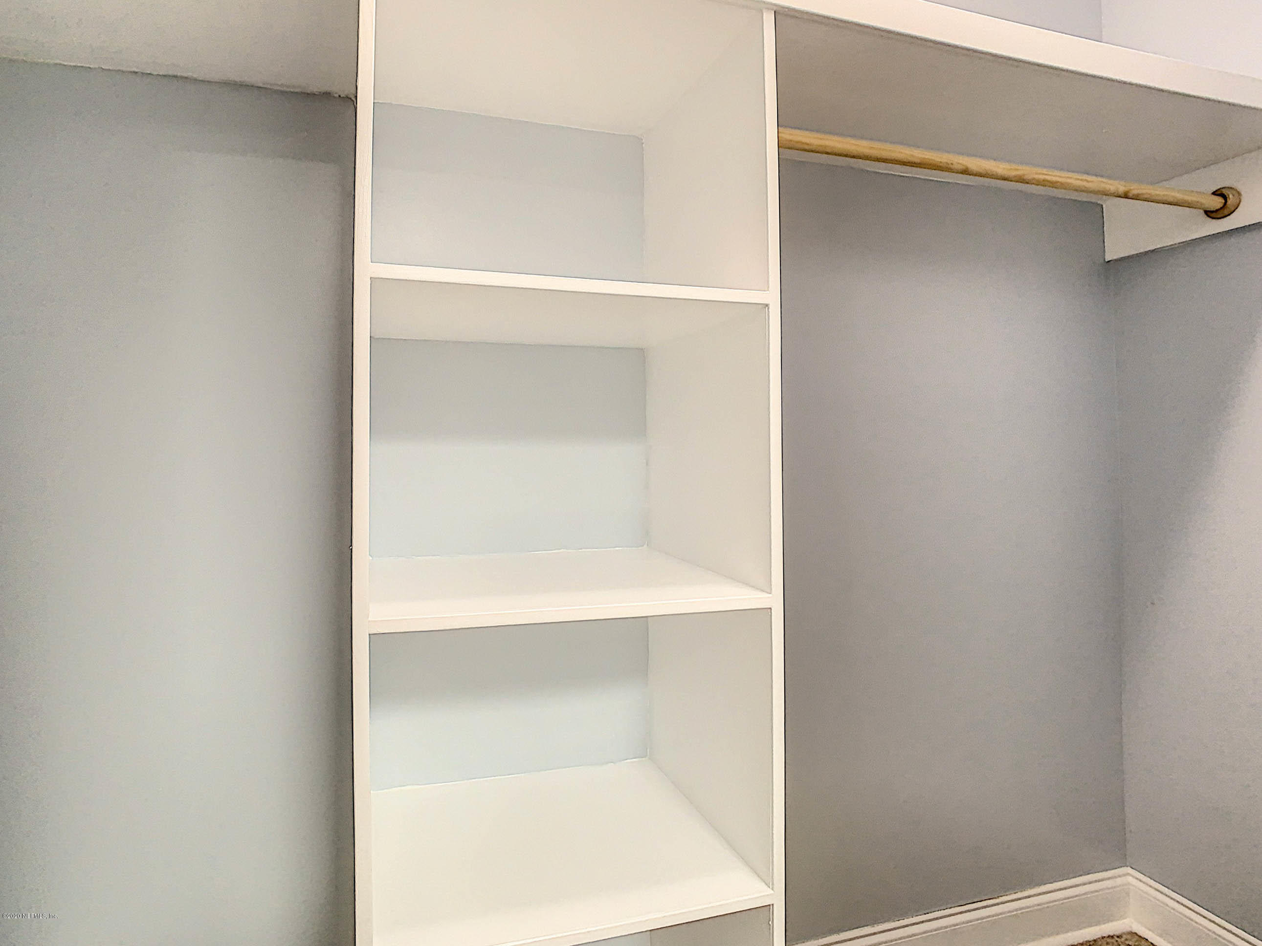 1609 First Street Neptune Beach, FL 32266 - Photo 21 of 30 a view of walk in closet with empty racks