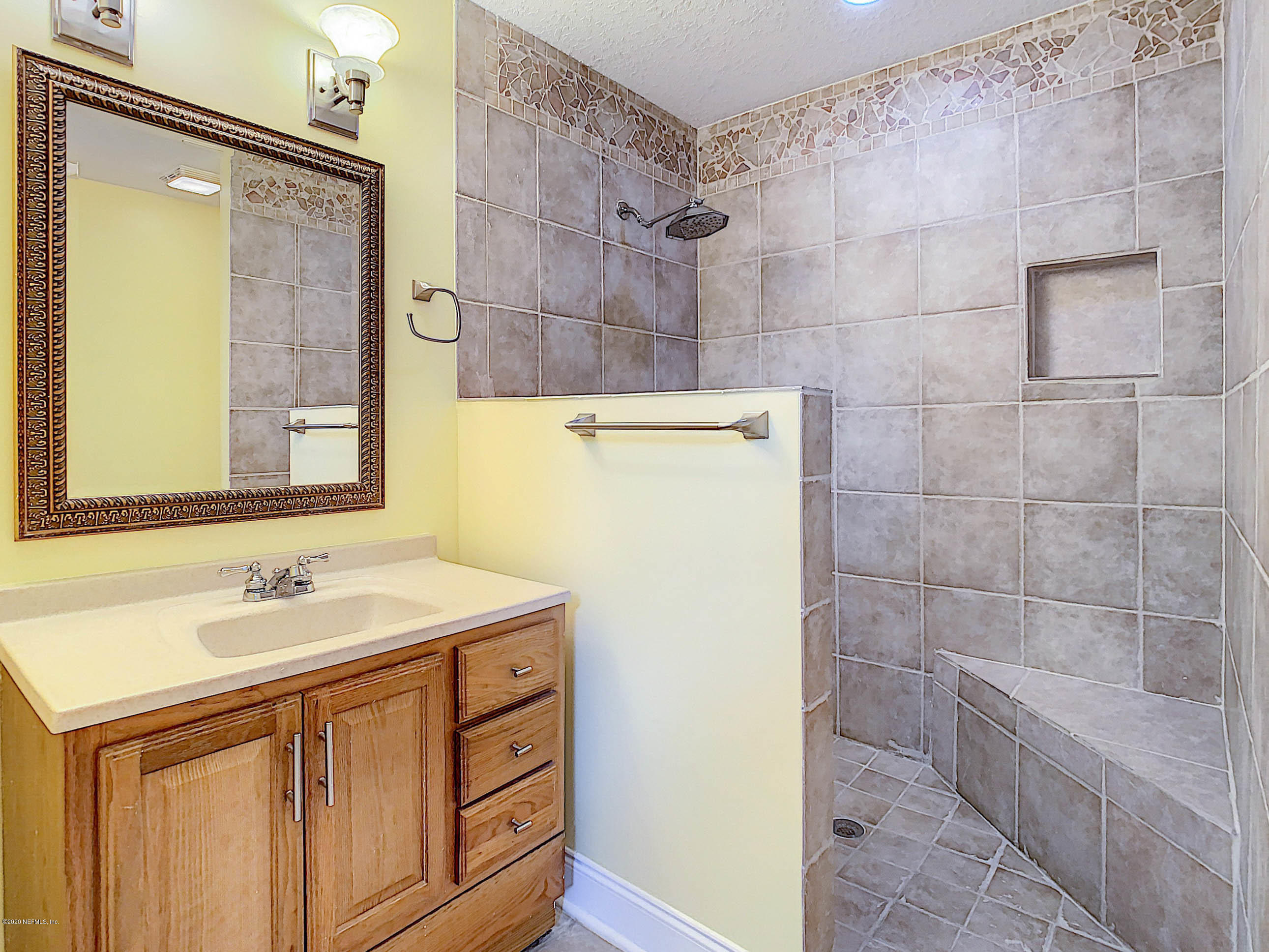 1609 First Street Neptune Beach, FL 32266 - Photo 23 of 30 a bathroom with a sink a vanity and a mirror