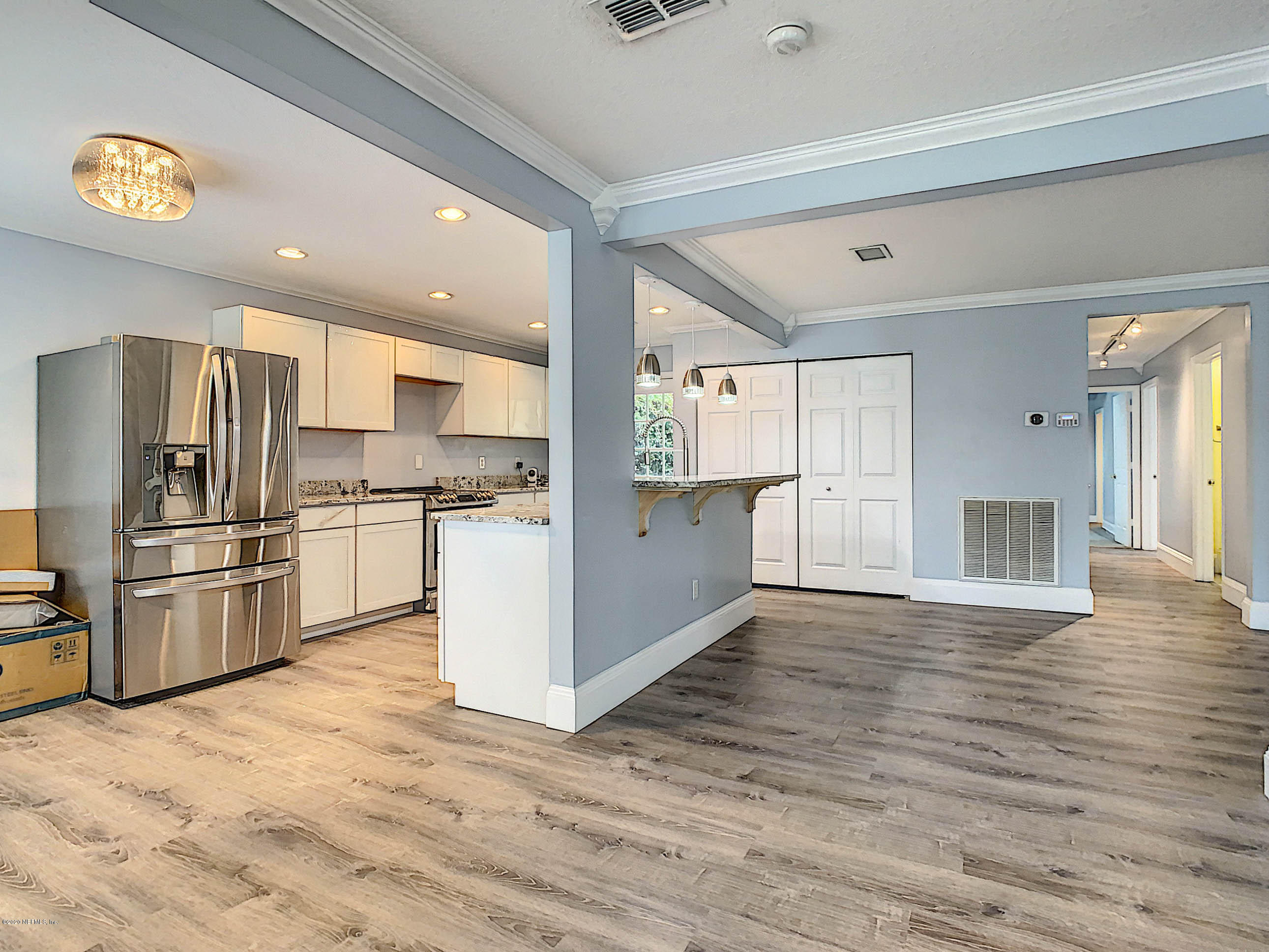 1609 First Street Neptune Beach, FL 32266 - Photo 4 of 30 a kitchen with granite countertop a refrigerator and a stove top oven