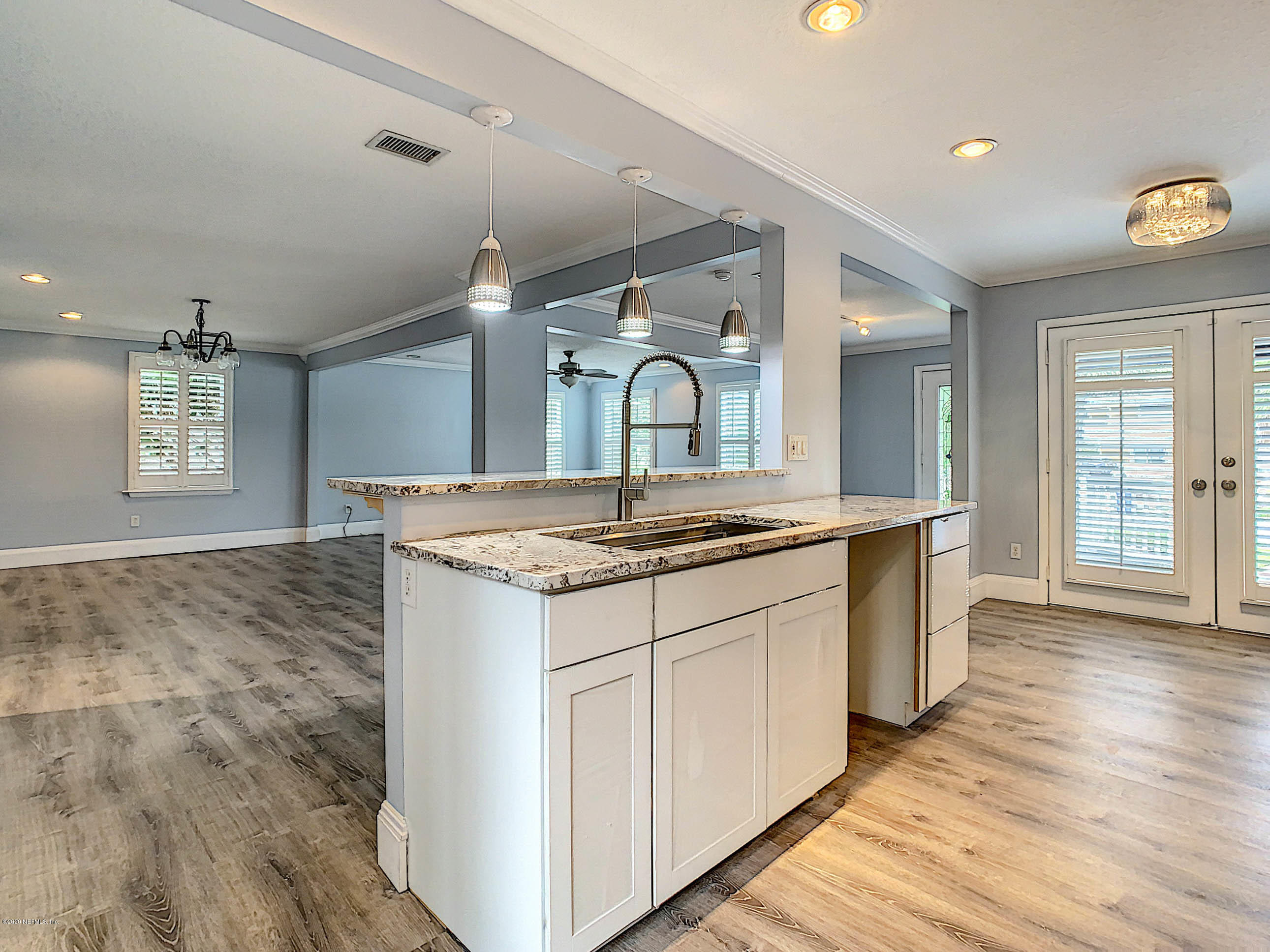 1609 First Street Neptune Beach, FL 32266 - Photo 8 of 30 a kitchen with granite countertop a sink and a stove