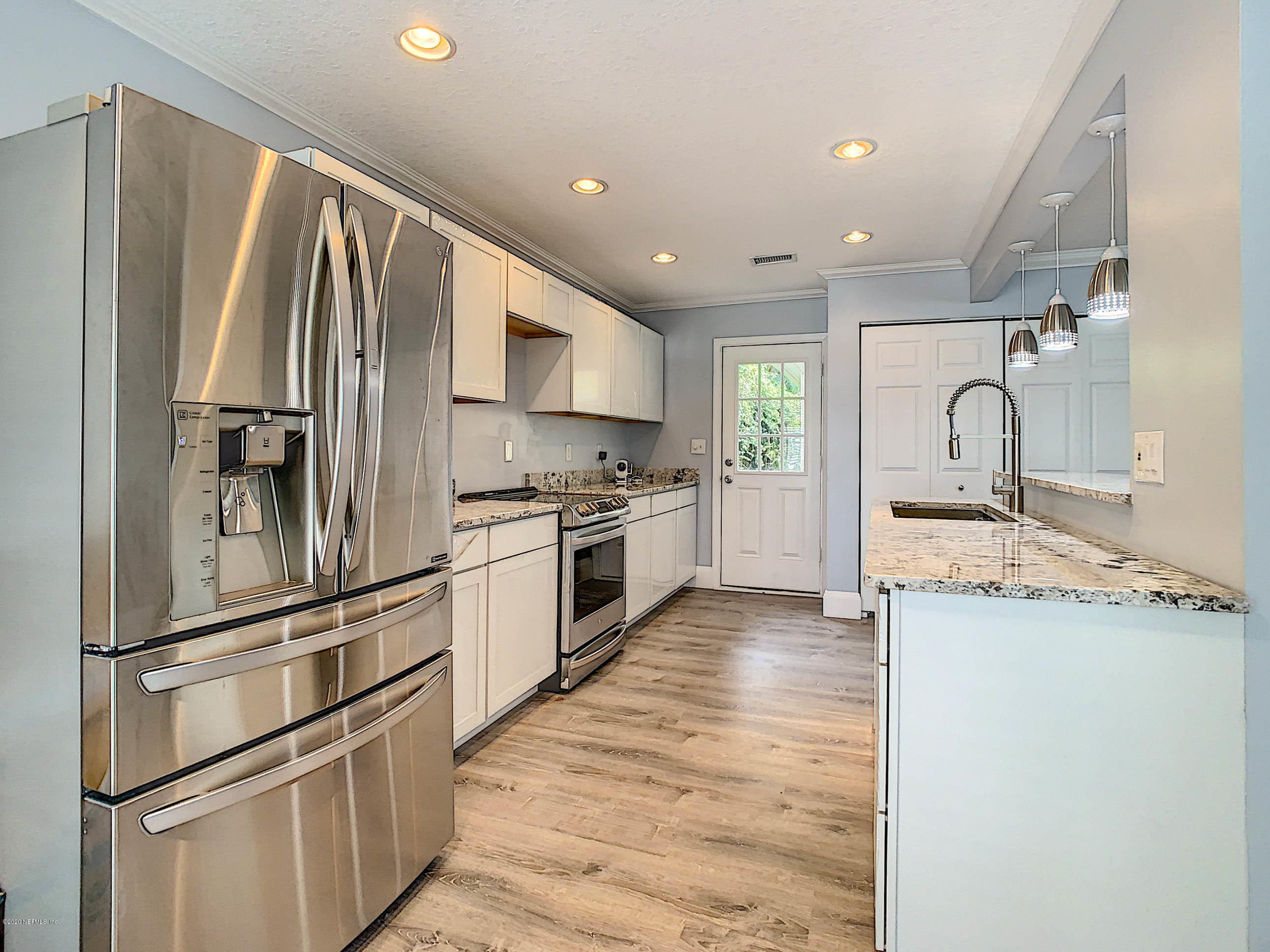 1609 First Street Neptune Beach, FL 32266 - Photo 9 of 30 a kitchen with granite countertop stainless steel appliances and wooden cabinets
