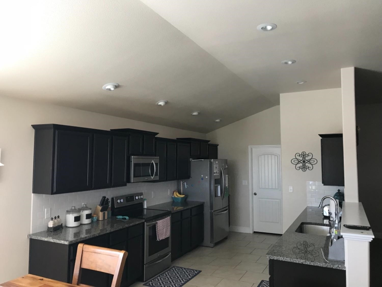 3643 Ridgely Avenue Lubbock, TX 79407 - Photo 5 of 10 a kitchen with stainless steel appliances granite countertop a refrigerator stove top oven a sink and dishwasher