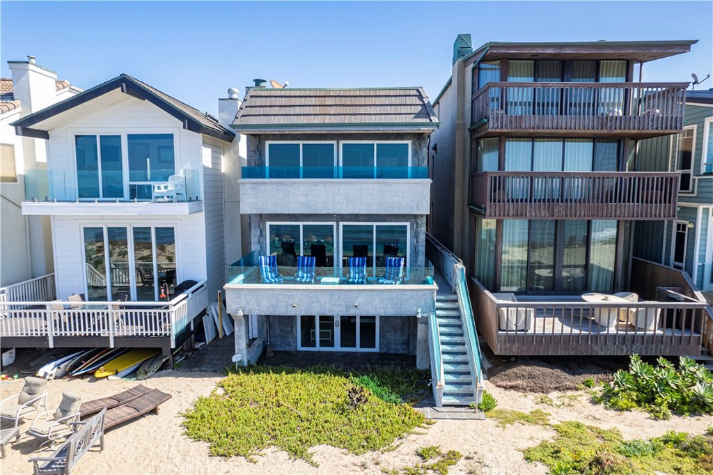 a view of a house with wooden fence and a small yard