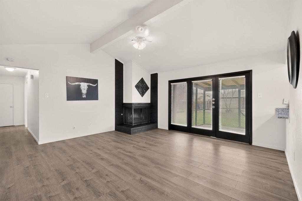 1538 Oakbrook Street Lancaster, TX 75134 - Photo 1 of 34 a view of an empty room with a window and wooden floor