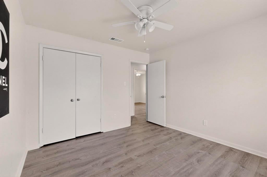 1538 Oakbrook Street Lancaster, TX 75134 - Photo 14 of 34 a view of an empty room with a fan