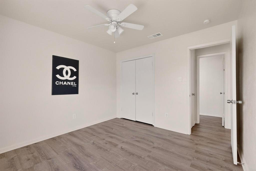 1538 Oakbrook Street Lancaster, TX 75134 - Photo 16 of 34 a view of an empty room with wooden floor