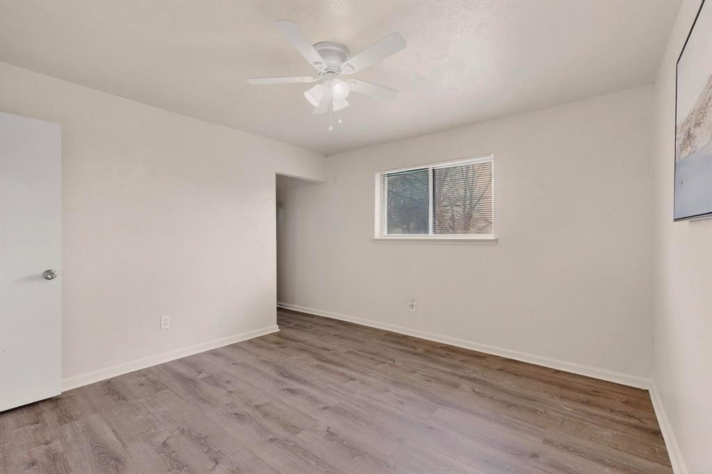 1538 Oakbrook Street Lancaster, TX 75134 - Photo 18 of 34 wooden floor in an empty room with a window