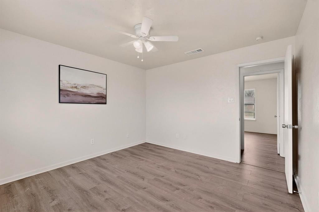 1538 Oakbrook Street Lancaster, TX 75134 - Photo 19 of 34 a view of an empty room with wooden floor