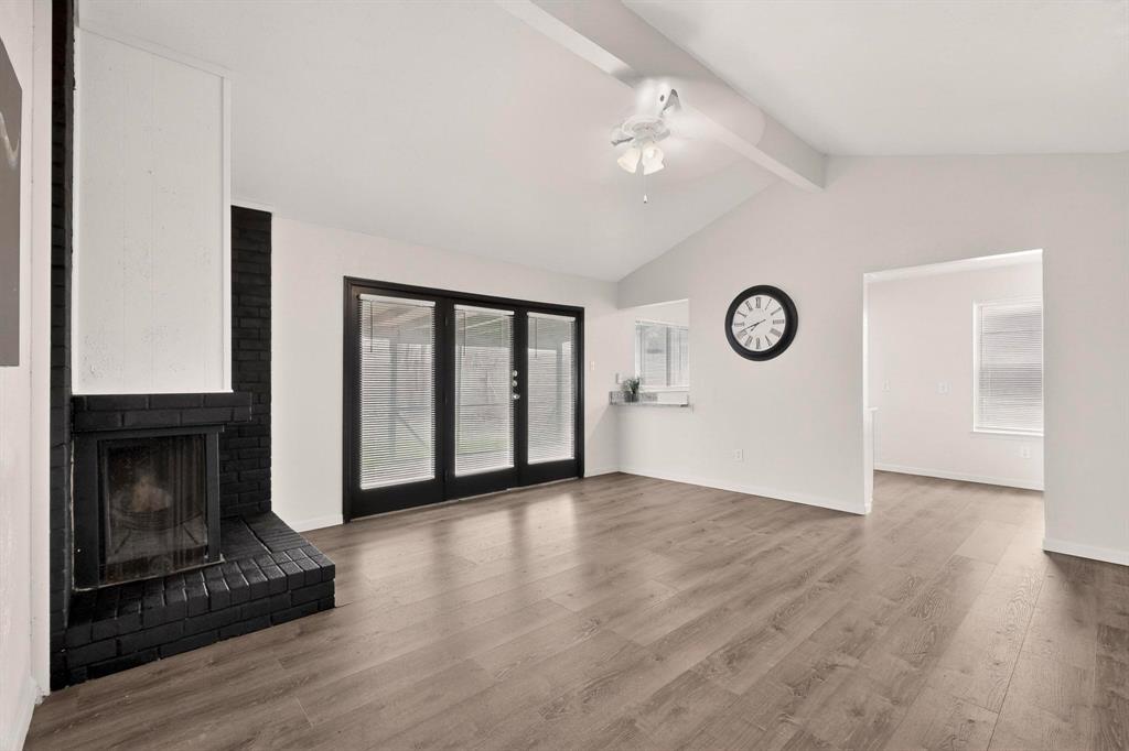1538 Oakbrook Street Lancaster, TX 75134 - Photo 2 of 34 a view of an empty room with window and wooden floor