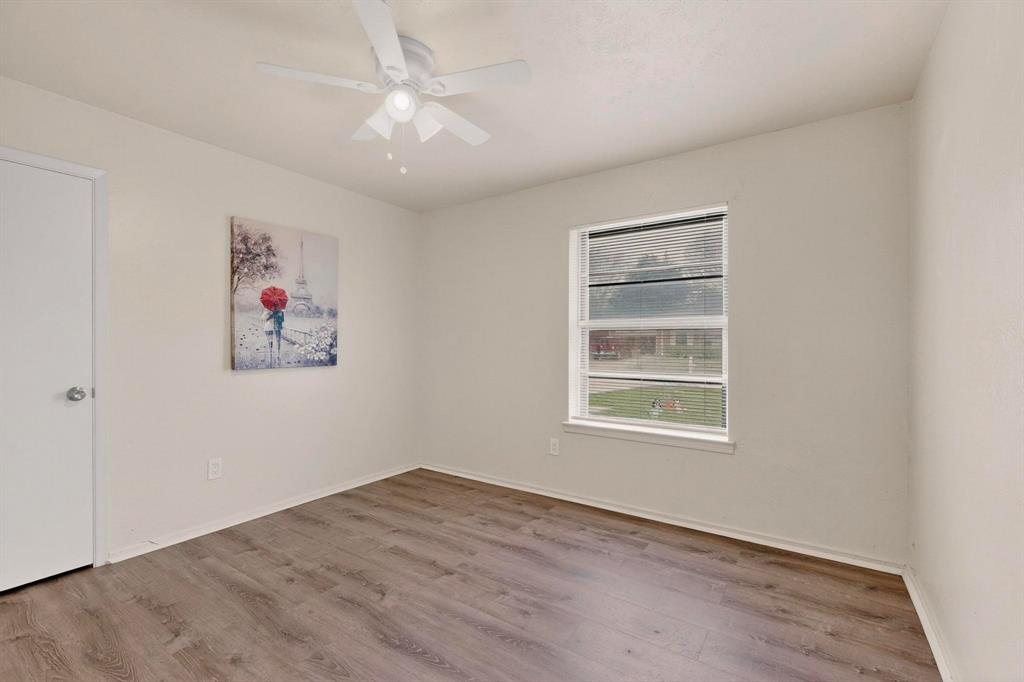 1538 Oakbrook Street Lancaster, TX 75134 - Photo 22 of 34 an empty room with a window and a ceiling fan