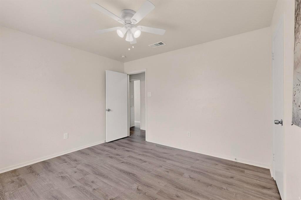 1538 Oakbrook Street Lancaster, TX 75134 - Photo 24 of 34 a view of an empty room with wooden floor