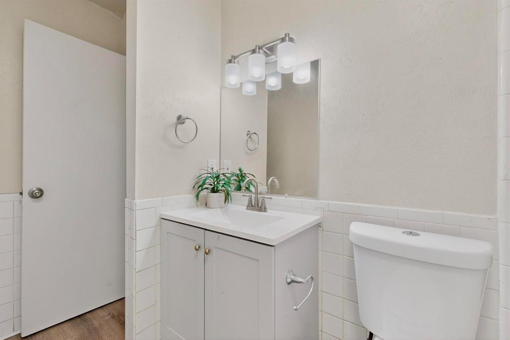 1538 Oakbrook Street Lancaster, TX 75134 - Photo 25 of 34 a bathroom with a sink a mirror and vanity