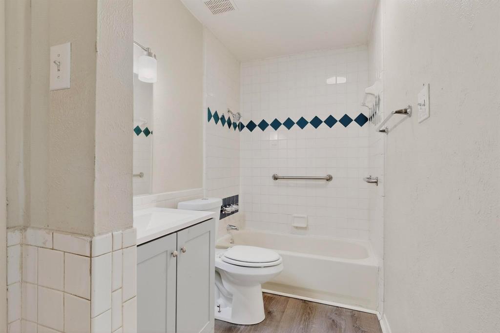 1538 Oakbrook Street Lancaster, TX 75134 - Photo 26 of 34 a bathroom with a toilet a sink and a shower