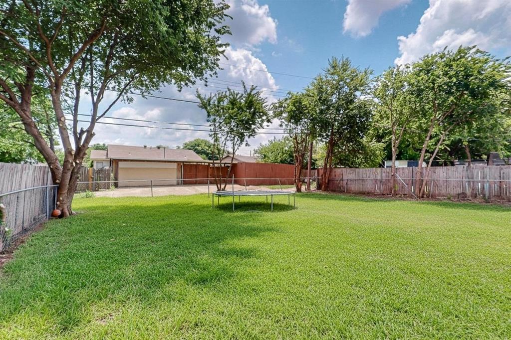 1538 Oakbrook Street Lancaster, TX 75134 - Photo 33 of 34 a view of garden with tree in the background