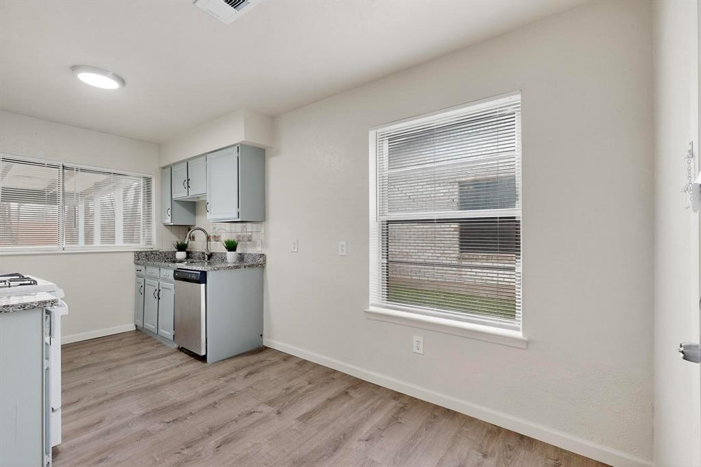 1538 Oakbrook Street Lancaster, TX 75134 - Photo 4 of 34 a kitchen with cabinets wooden floor and a window