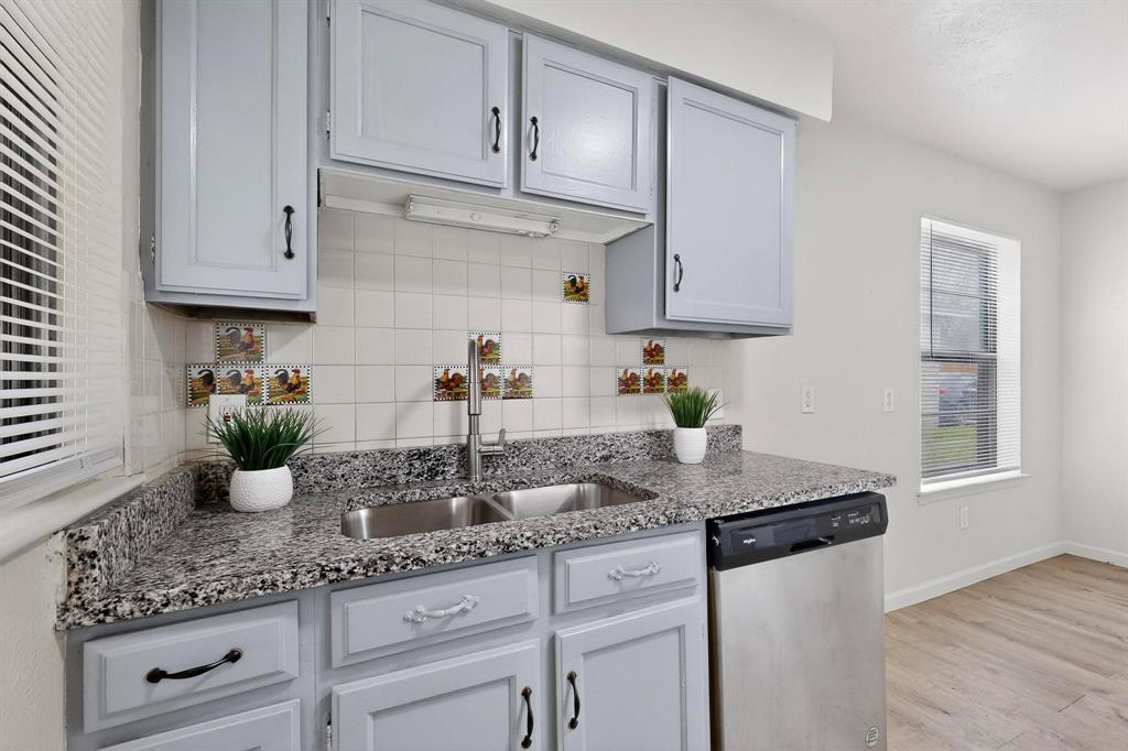 1538 Oakbrook Street Lancaster, TX 75134 - Photo 9 of 34 a kitchen with white cabinets and a granite counter tops