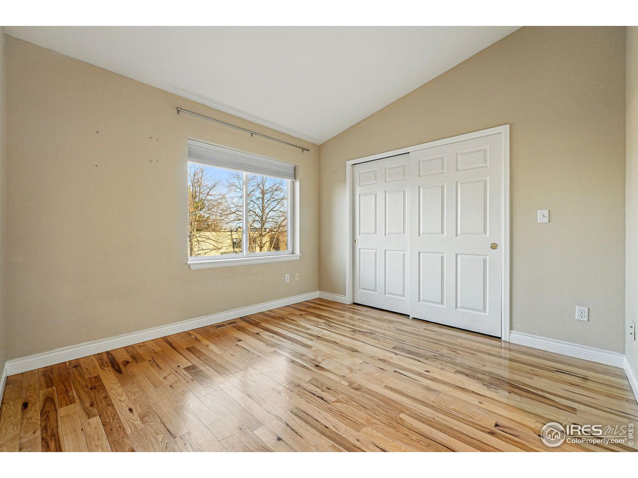 2700 Valmont Road, Unit 5 Boulder, CO 80304 - Photo 20 of 35 a view of an empty room with wooden floor and a window
