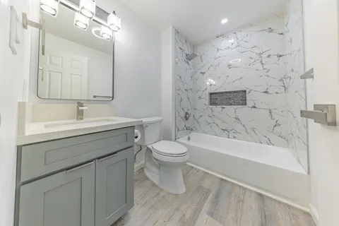 a bathroom with a sink a toilet and a bathtub