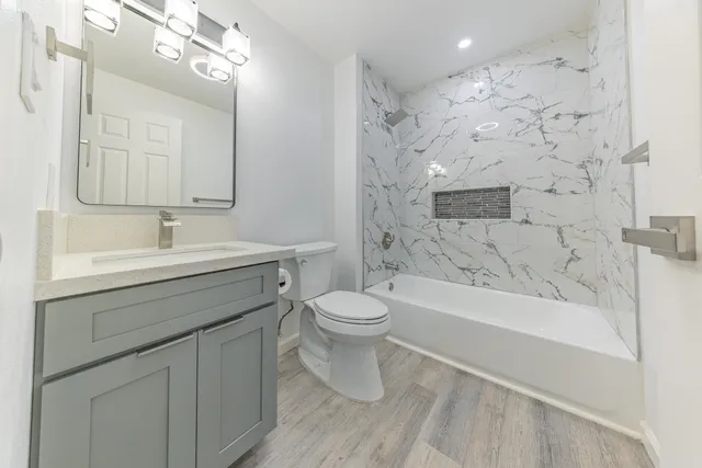 a bathroom with a sink a toilet and a bathtub