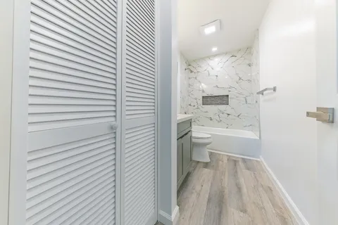 a bathroom with a sink a toilet and shower
