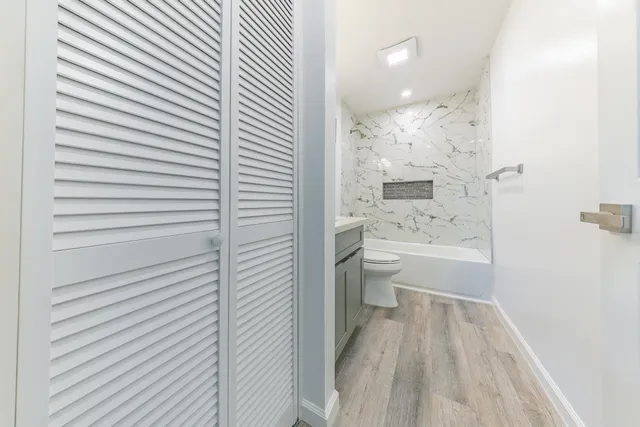 a bathroom with a sink a toilet and shower