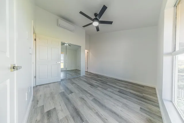 wooden floor in an empty room with a window
