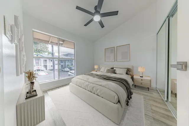 a spacious bedroom with a bed and a large window