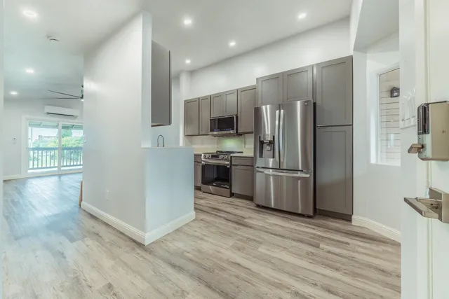 a kitchen with stainless steel appliances a refrigerator and a stove top oven