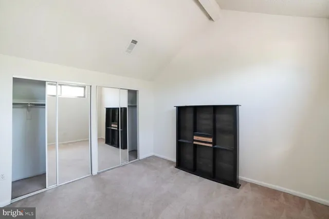 a view of a livingroom with wooden floor and stairs