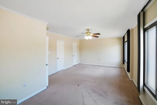 an empty room with windows and closet