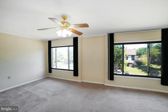 a view of a room with a ceiling fan and a window