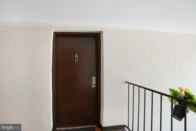 a picture of a room with a bench and white walls