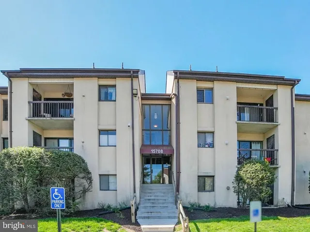 a picture of a bench in front of a building