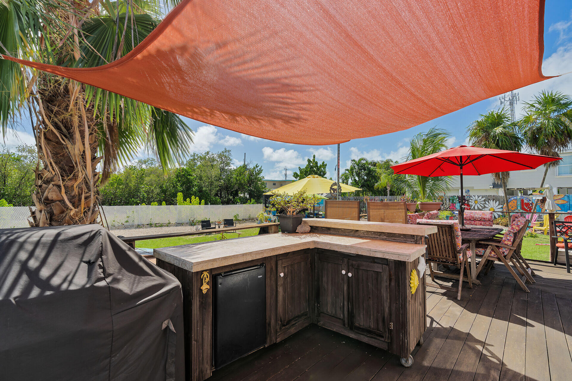 357 23rd Street Marathon, FL 33050 - Photo 17 of 48 a view of a backyard with swimming pool and table and chairs under an umbrella