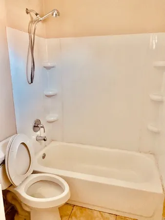 a bathroom with a sink a toilet and a shower