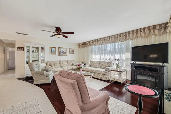 a living room with furniture a flat screen tv and a fireplace