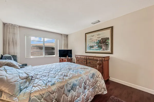 a bedroom with a large bed and a window